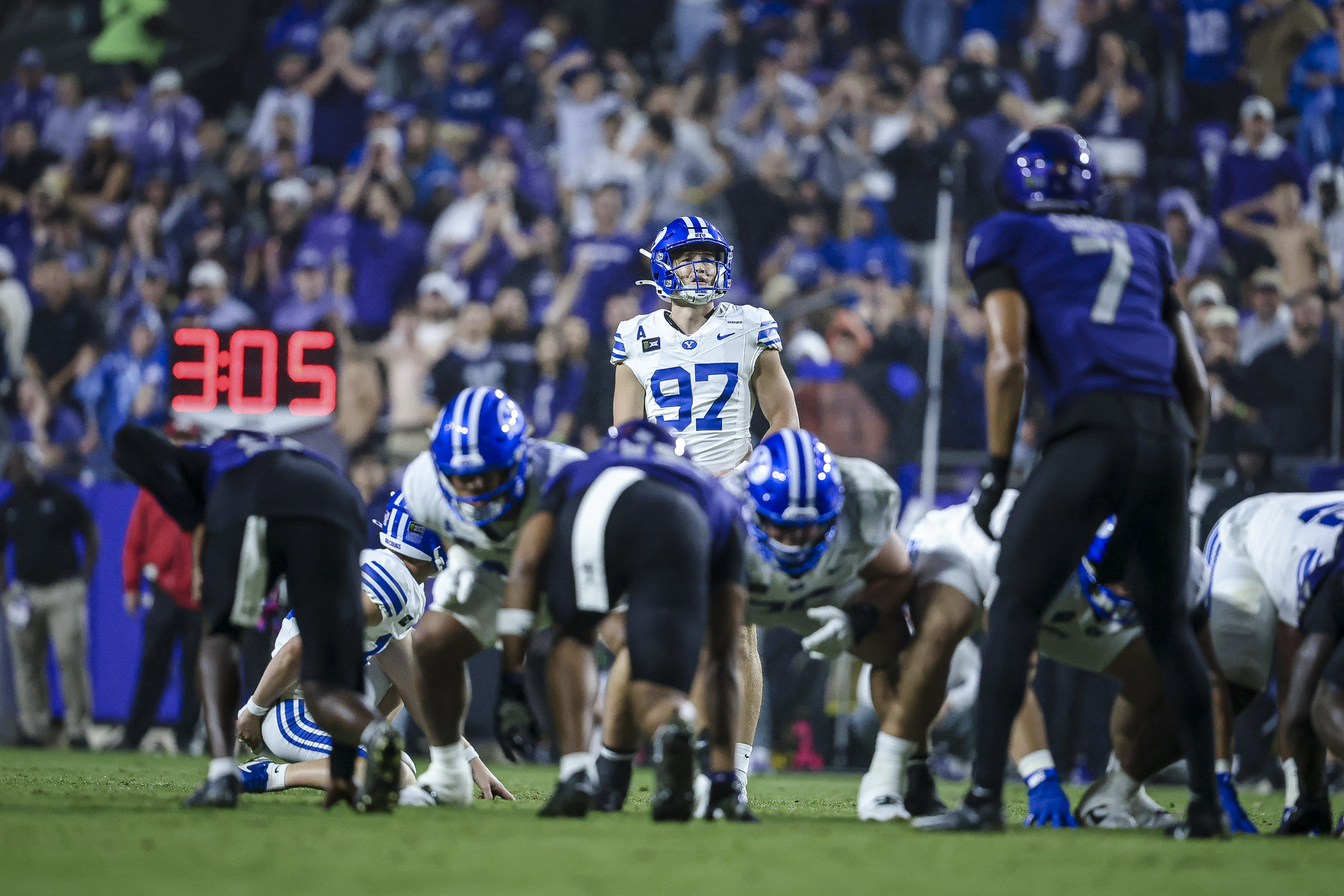 BYU quarterback Bear Bachmeier carrying the ball during the rainy TCU game.