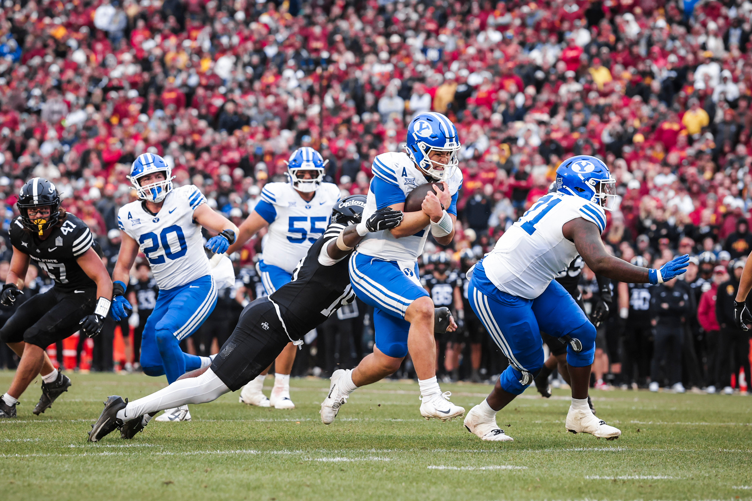 BYU football and Iowa State players contesting a play in a Big 12 game.