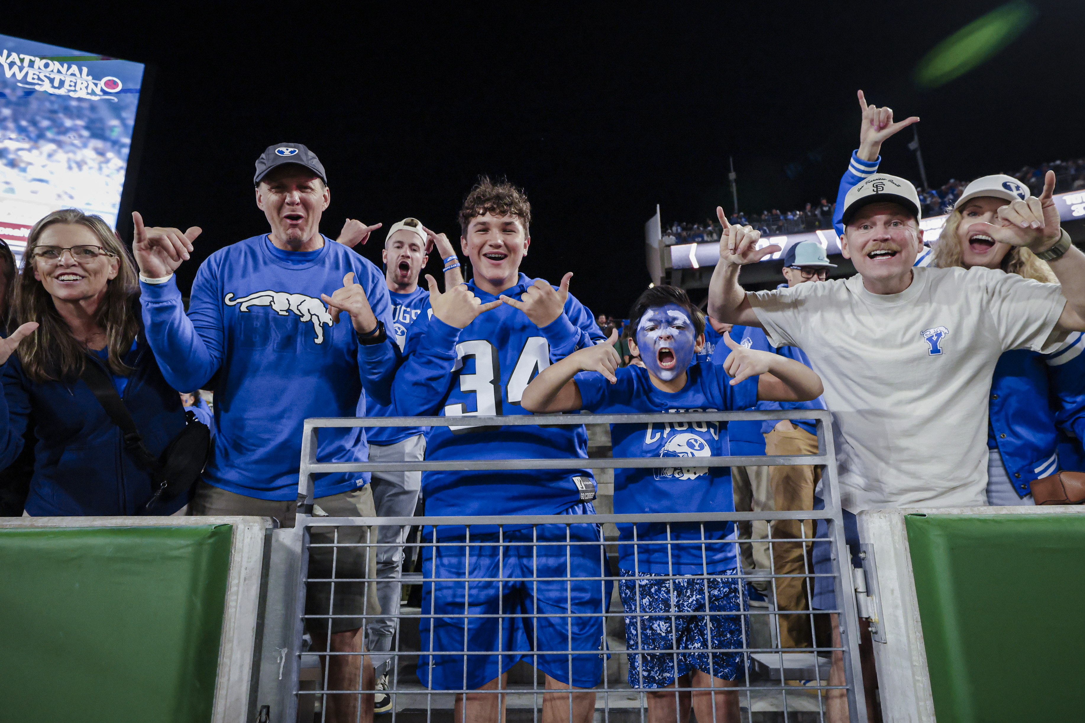 BYU fans celebrating in the stands after a football game
