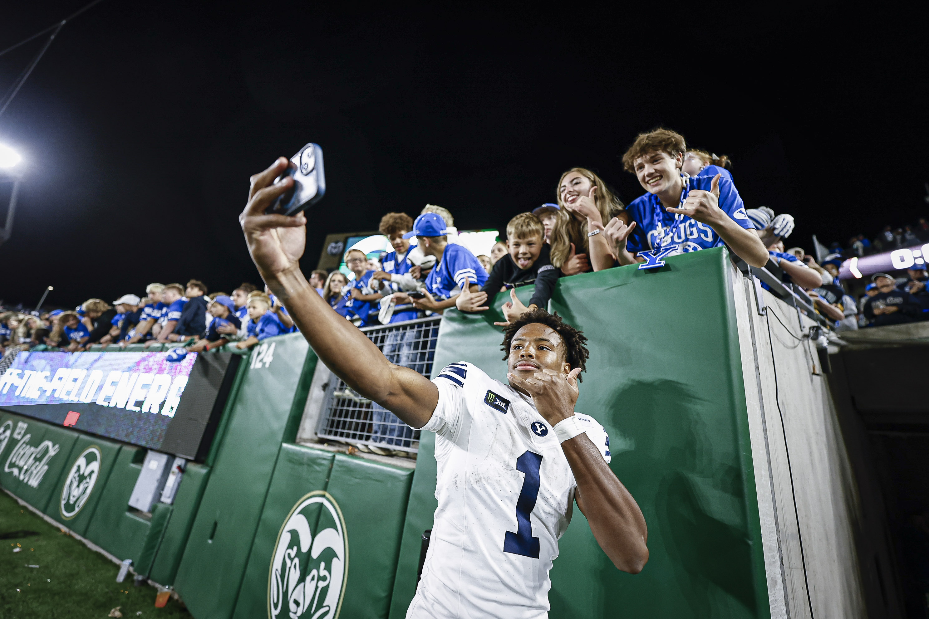 BYU player celebrating with fans after a game