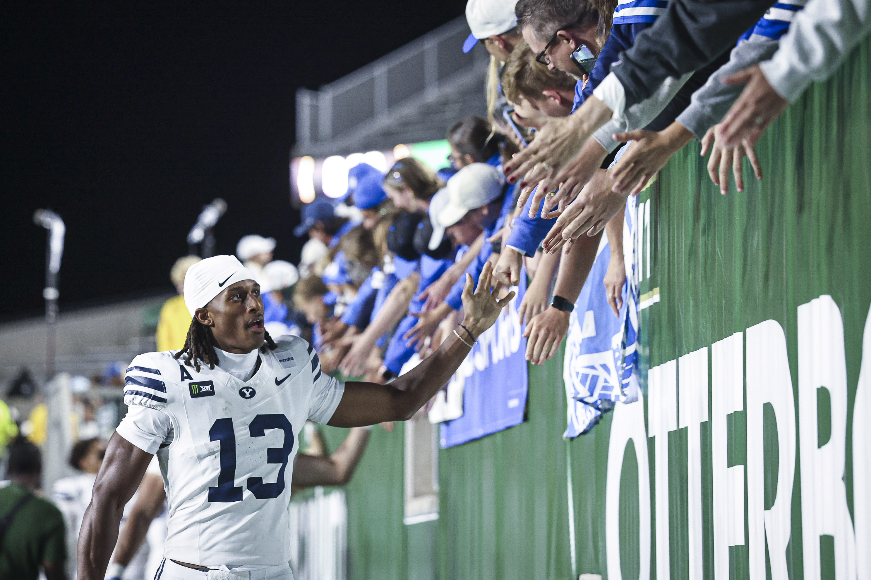 BYU receiver greeting fans along the sideline