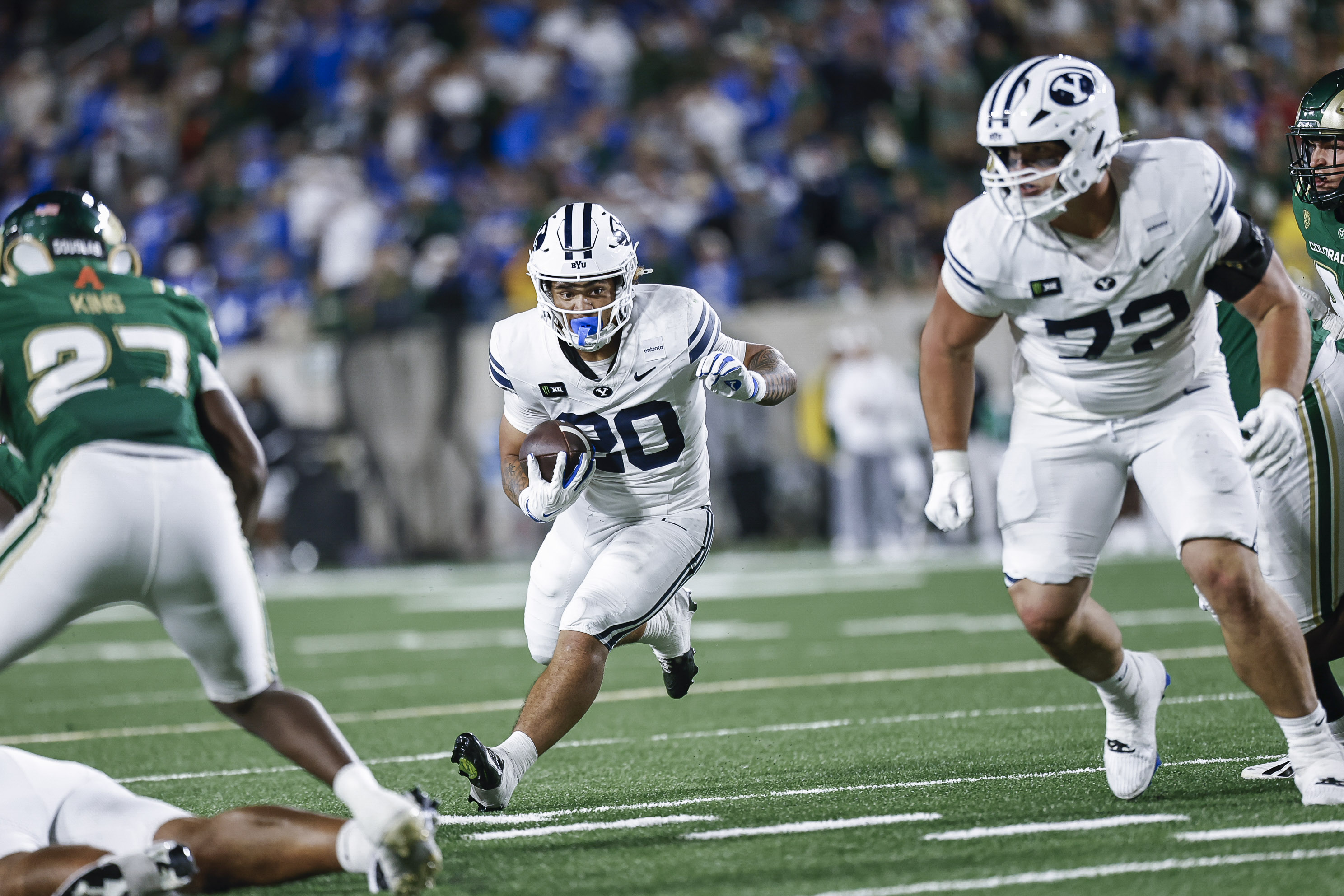 BYU running back carrying the ball in a football game